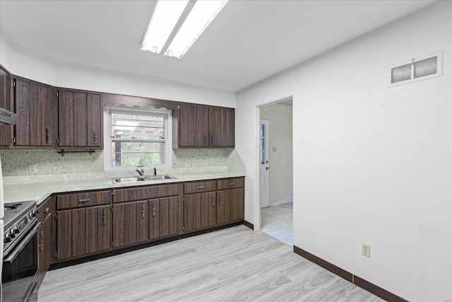 kitchen featuring decorative backsplash, dark brown cabinetry, and black / electric stove