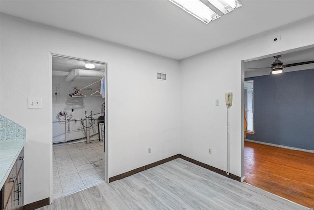 spare room with ceiling fan and light hardwood / wood-style floors