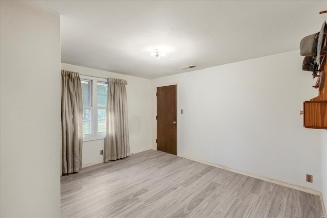 spare room with light hardwood / wood-style floors