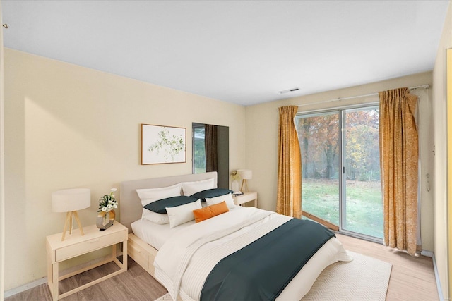 bedroom featuring light hardwood / wood-style floors and access to outside