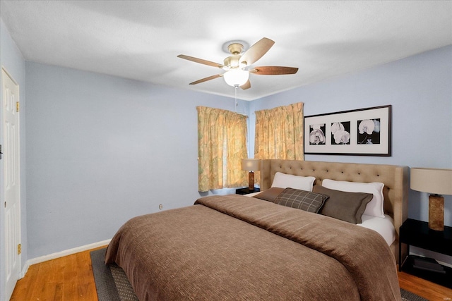 bedroom featuring hardwood / wood-style floors and ceiling fan