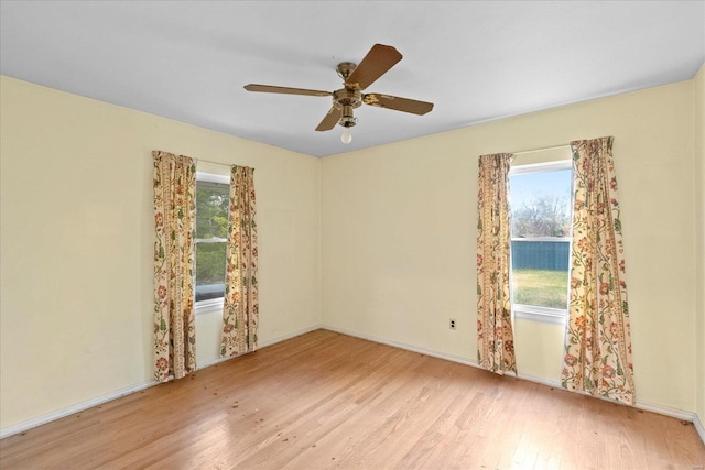 spare room with ceiling fan and light wood-type flooring