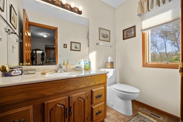 bathroom with tile patterned floors, vanity, and toilet