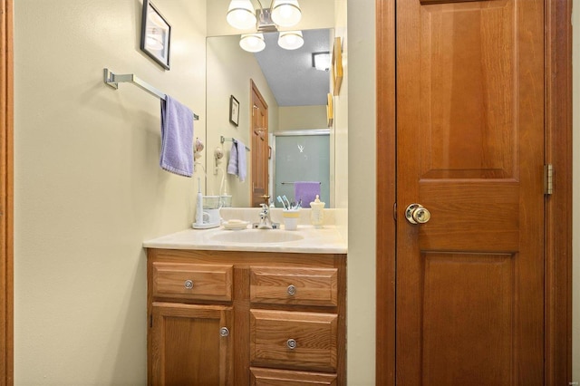 bathroom with vanity and a shower with door