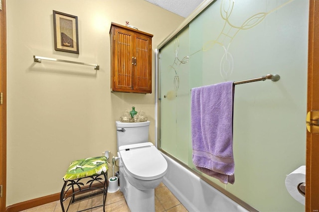 bathroom featuring tile patterned flooring, toilet, bath / shower combo with glass door, and a textured ceiling