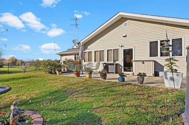 rear view of house with a yard, a patio, and central AC unit