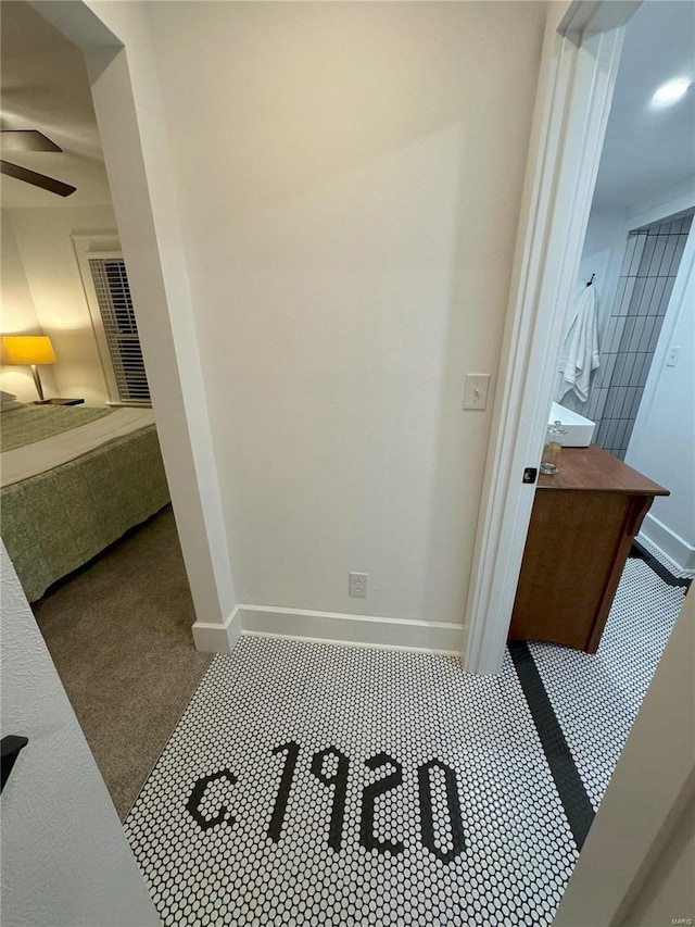 bathroom with ceiling fan and tile patterned flooring