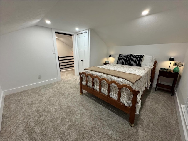 bedroom with carpet floors and vaulted ceiling