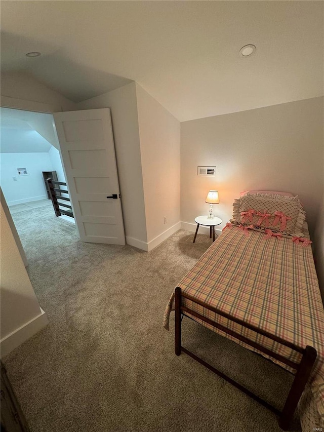 bedroom with lofted ceiling and carpet floors