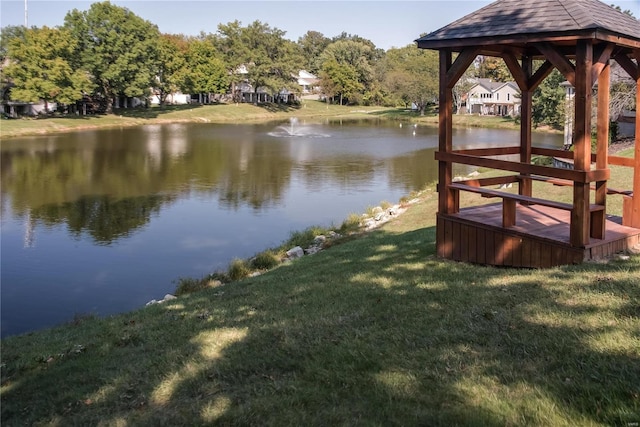 view of dock featuring a gazebo, a yard, and a water view