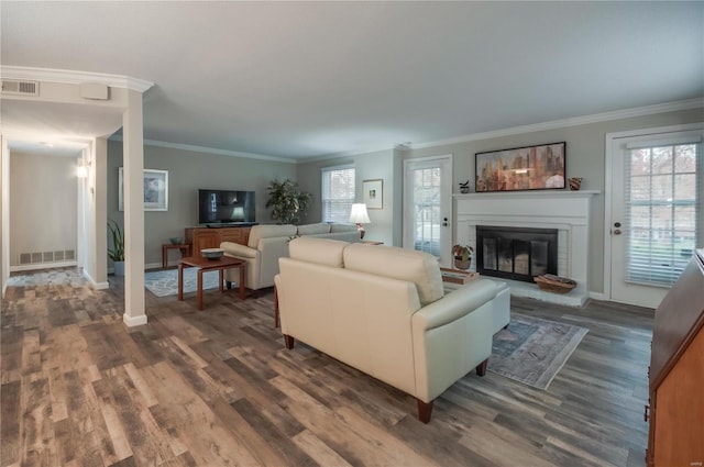 living room with dark wood-type flooring and ornamental molding