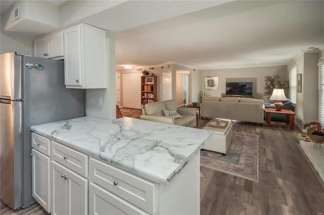 kitchen with white cabinets, stainless steel fridge, dark hardwood / wood-style flooring, and crown molding