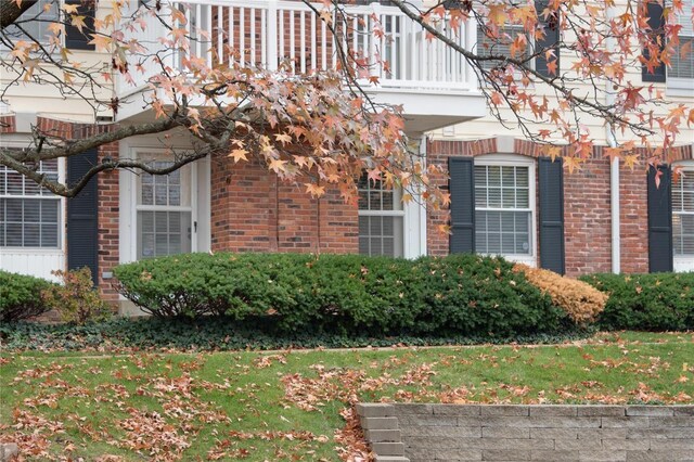 view of side of home featuring a balcony