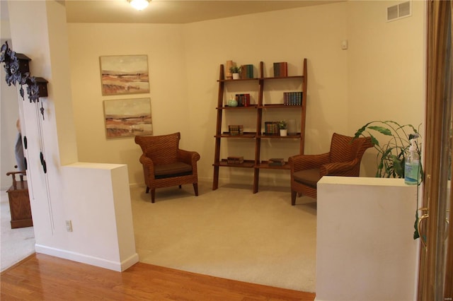 sitting room featuring wood-type flooring