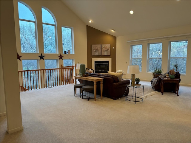 living room with light carpet and high vaulted ceiling