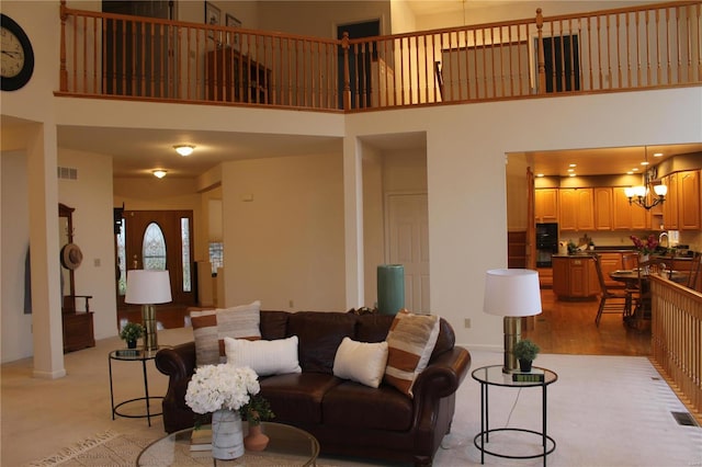 living room with a towering ceiling and light hardwood / wood-style floors