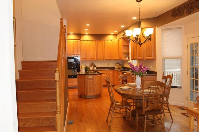 dining room with a chandelier and wood-type flooring