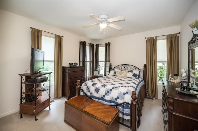 carpeted bedroom with multiple windows and ceiling fan