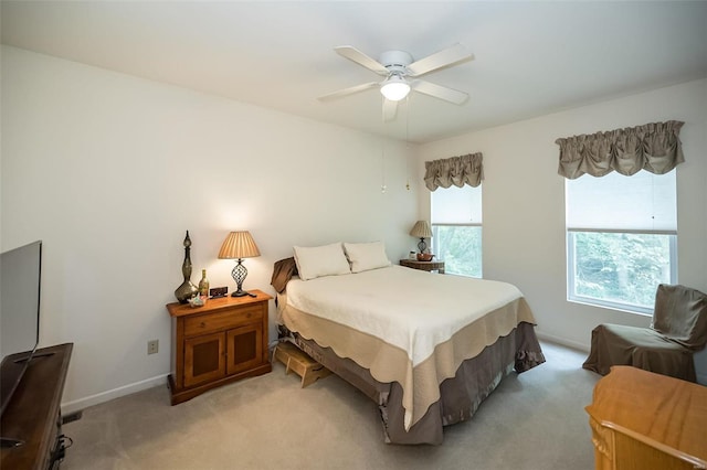 bedroom featuring ceiling fan and light carpet