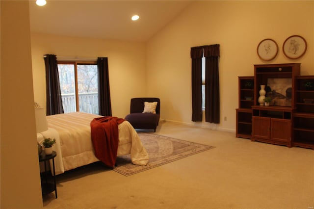 carpeted bedroom with high vaulted ceiling