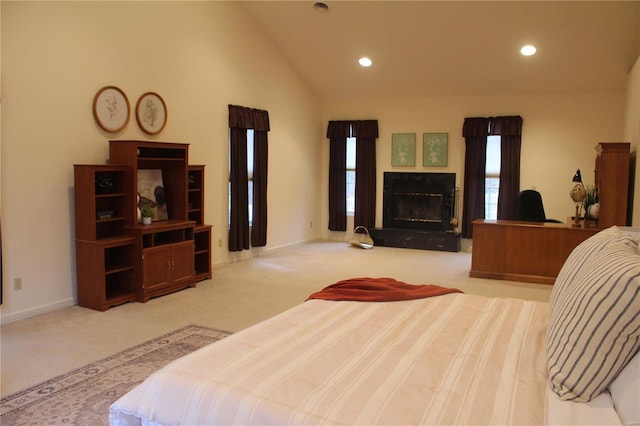 bedroom with light carpet and high vaulted ceiling