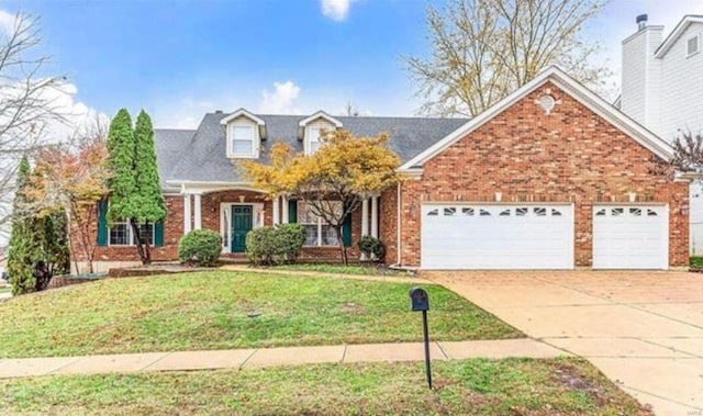 view of front of house with a garage and a front yard