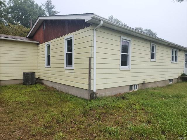 view of side of property with a lawn