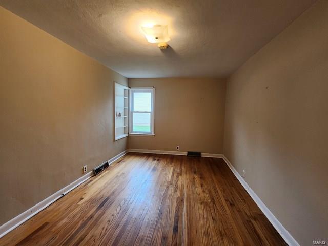 empty room featuring wood-type flooring