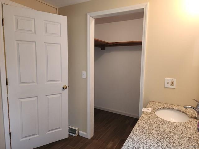 interior space with vanity and hardwood / wood-style flooring