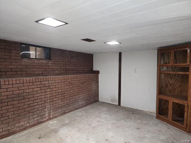 basement with brick wall