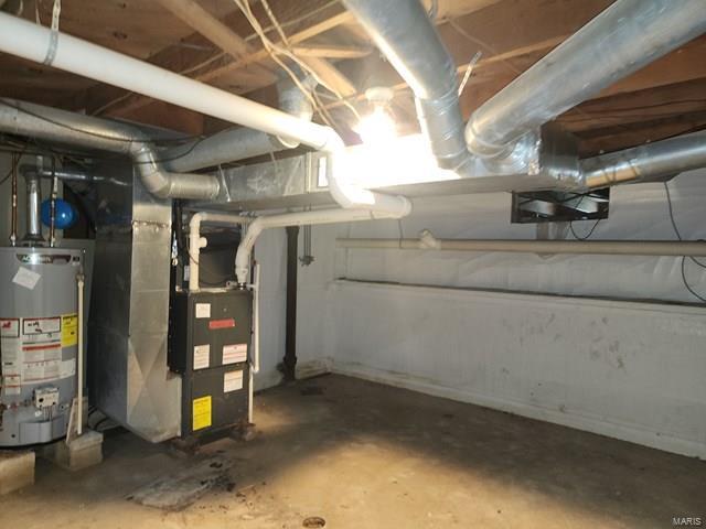 basement featuring heating unit and water heater