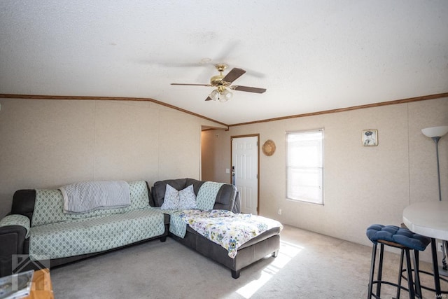 living room with a textured ceiling, ceiling fan, carpet floors, and lofted ceiling