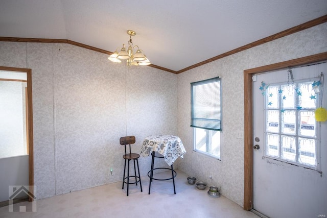 sitting room with a chandelier, carpet floors, crown molding, and lofted ceiling