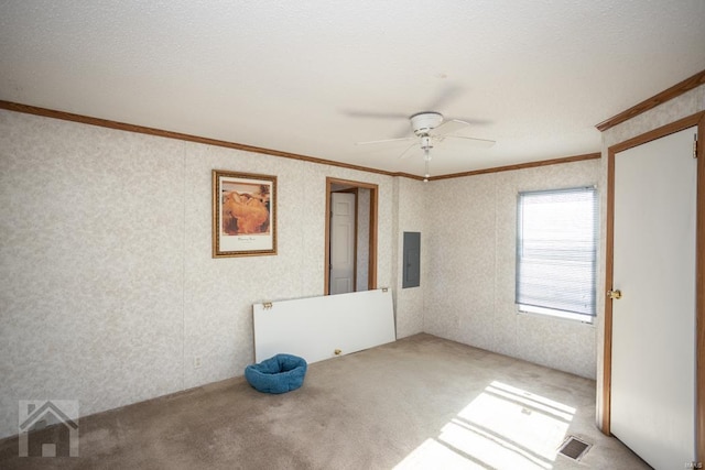 empty room with electric panel, ceiling fan, light colored carpet, and ornamental molding