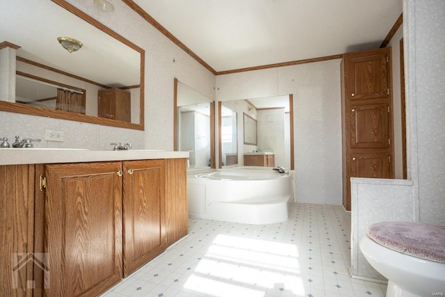 bathroom featuring a bathing tub, toilet, vanity, and ornamental molding