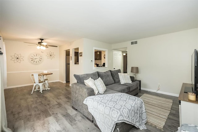 living room with hardwood / wood-style flooring and ceiling fan