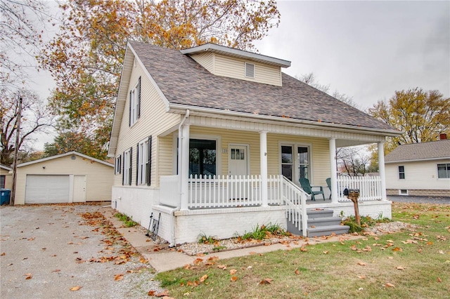 bungalow with a porch, an outdoor structure, and a garage