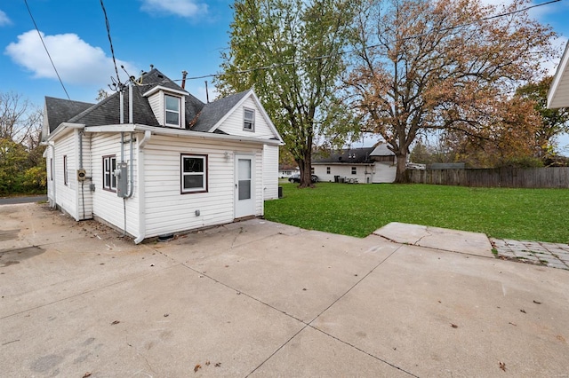 rear view of property with a yard