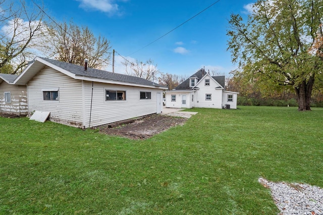 rear view of property featuring a yard