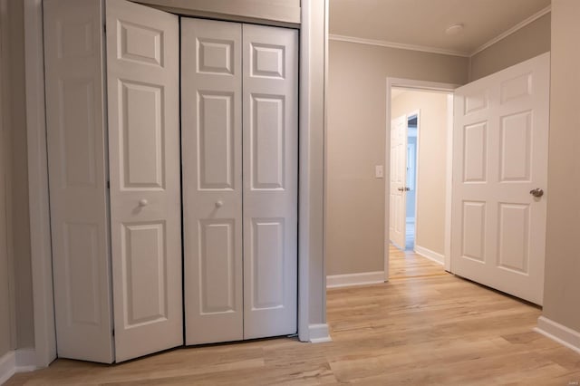 interior space featuring light wood-type flooring and ornamental molding