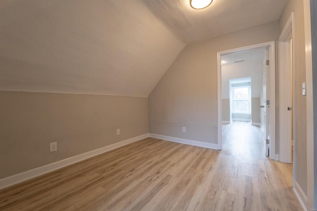 bonus room featuring light hardwood / wood-style floors and lofted ceiling