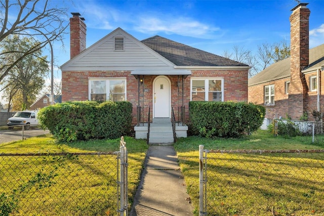 bungalow-style house with a front lawn