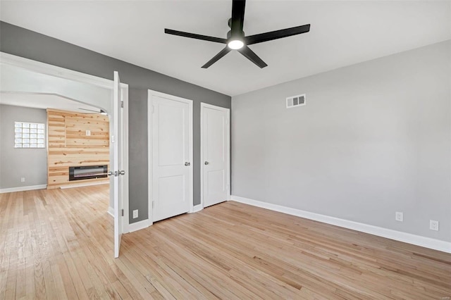 unfurnished bedroom with hardwood / wood-style floors and ceiling fan