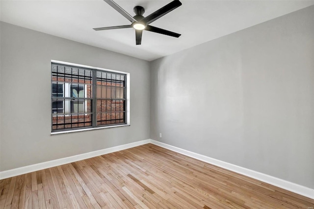 empty room featuring hardwood / wood-style floors and ceiling fan