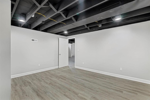 basement featuring hardwood / wood-style floors