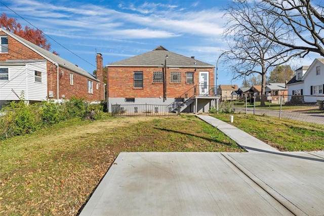 rear view of house with a yard