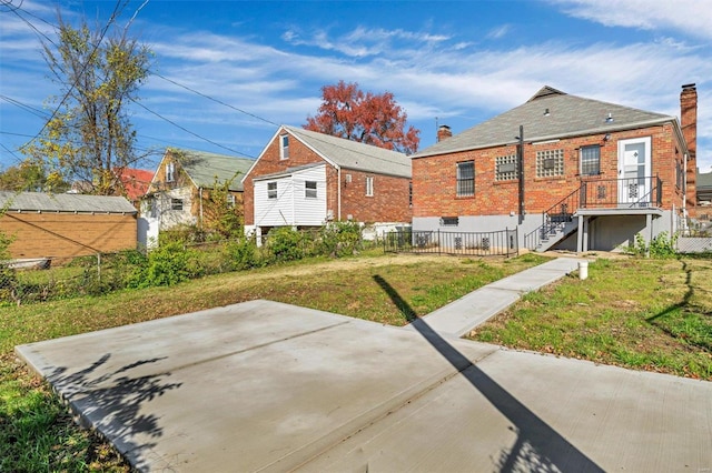 rear view of house featuring a yard