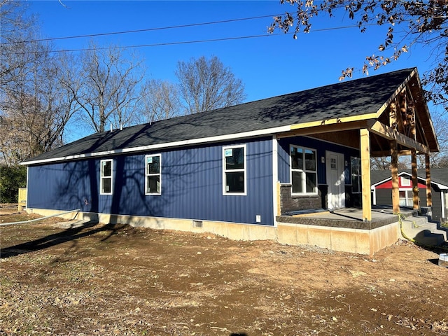 view of side of home with a porch