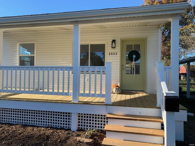 entrance to property featuring a porch