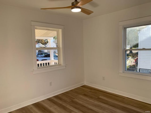 empty room with dark hardwood / wood-style flooring and ceiling fan